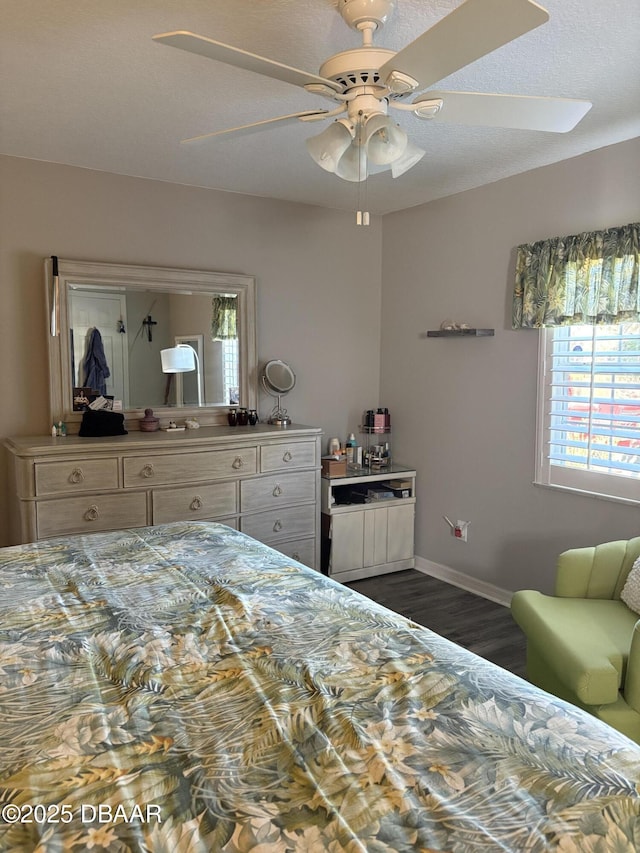 bedroom with dark hardwood / wood-style floors and ceiling fan