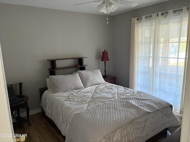 bedroom with ceiling fan and dark hardwood / wood-style flooring