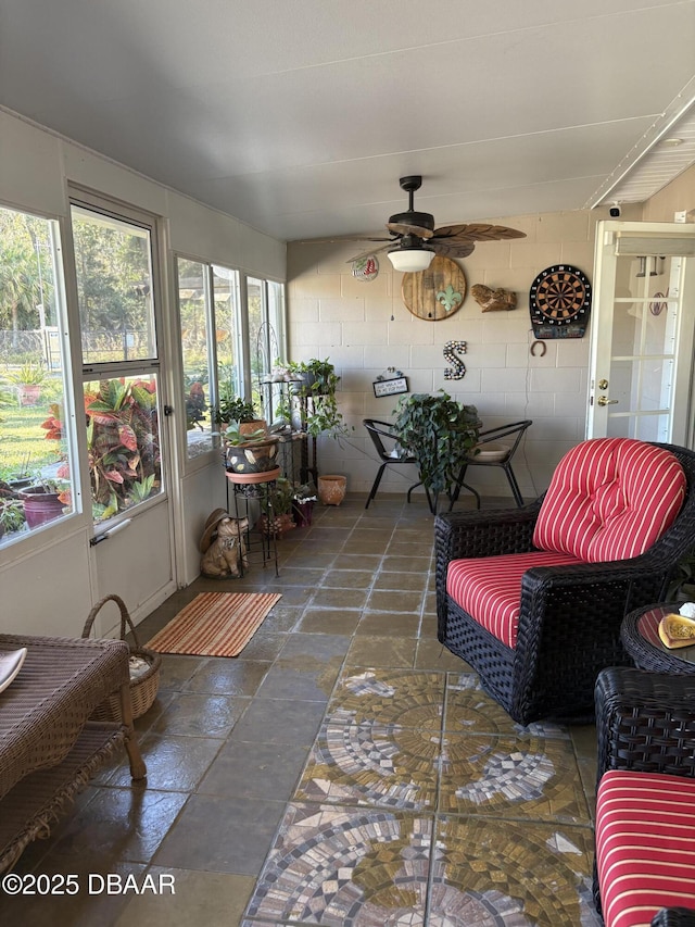 sunroom featuring ceiling fan