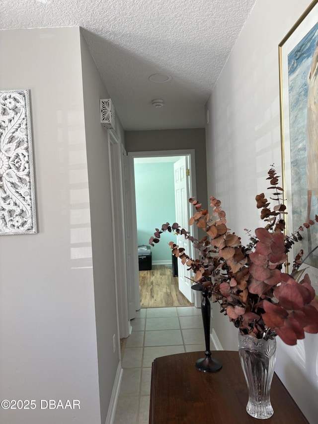 hallway featuring a textured ceiling