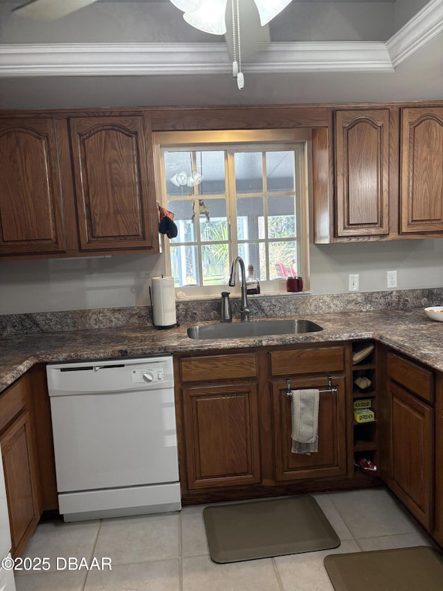 kitchen featuring light tile patterned flooring, sink, crown molding, dishwasher, and dark stone counters