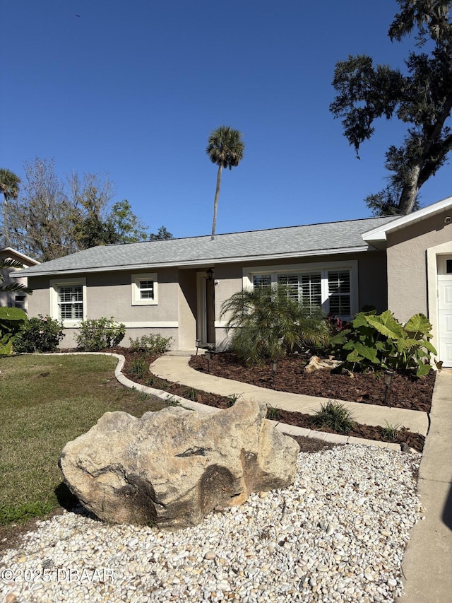 ranch-style home featuring a front yard