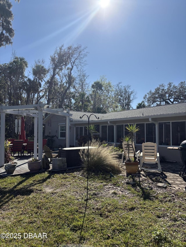 rear view of property with a pergola, a yard, and a patio