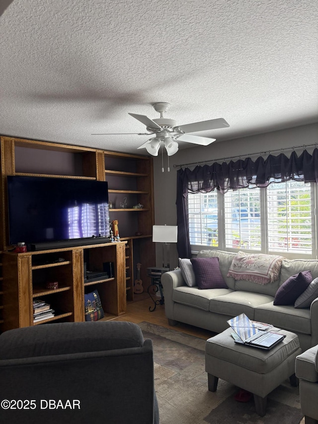 living room featuring a textured ceiling and ceiling fan