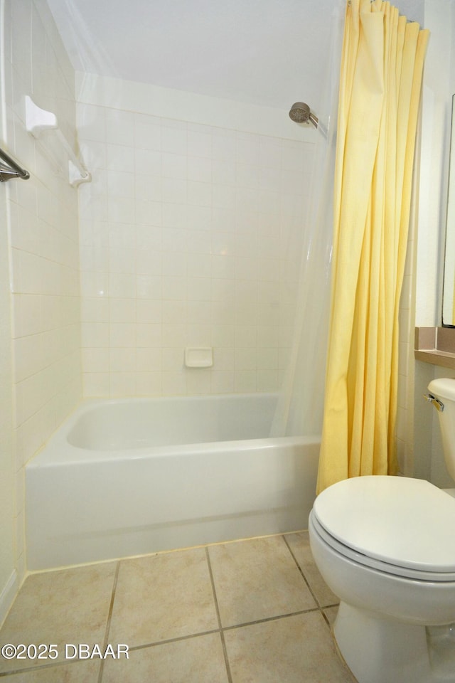 bathroom with tile patterned flooring, shower / tub combo, and toilet