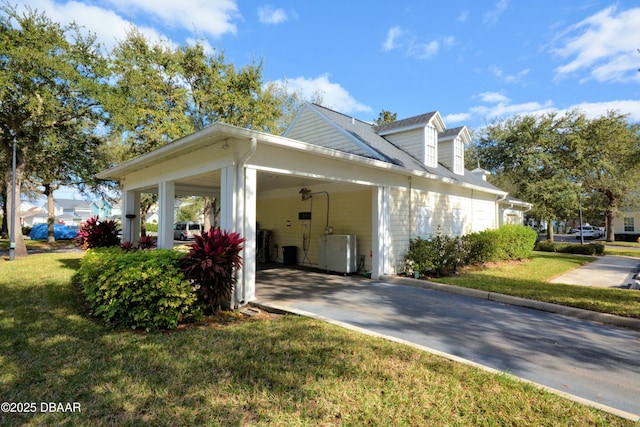 view of side of property with a carport and a yard