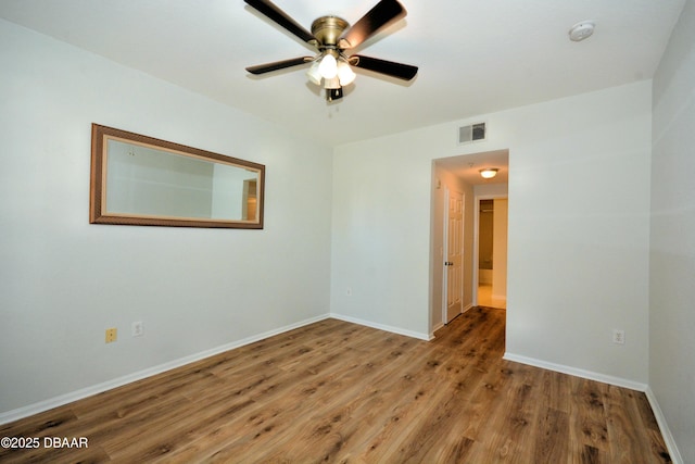 unfurnished room with hardwood / wood-style flooring and ceiling fan