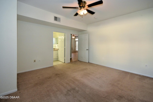 unfurnished room with ceiling fan and light carpet