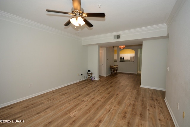 spare room featuring hardwood / wood-style flooring, ornamental molding, and ceiling fan