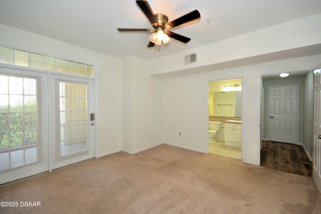 unfurnished room with light carpet and ceiling fan