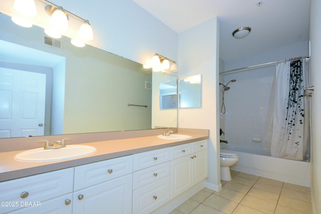 full bathroom with vanity, tile patterned floors, toilet, and shower / bath combo