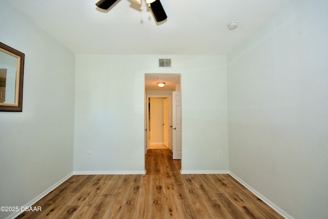 spare room with hardwood / wood-style flooring and ceiling fan