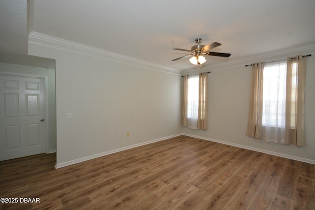 spare room with dark hardwood / wood-style flooring, crown molding, and ceiling fan