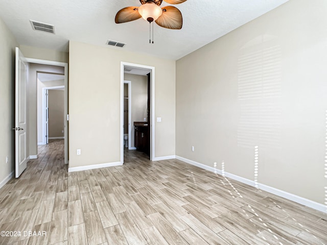 unfurnished bedroom with a textured ceiling, light hardwood / wood-style flooring, and ceiling fan