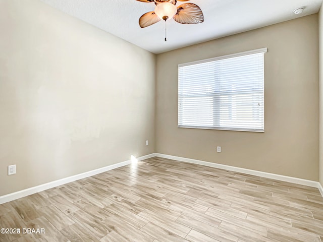 spare room featuring ceiling fan and light wood-type flooring