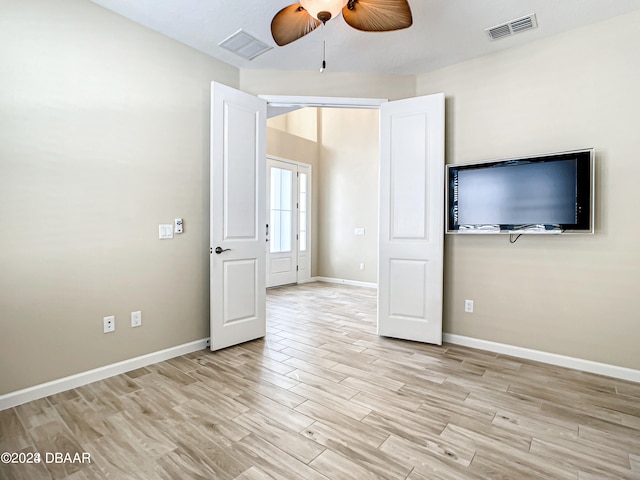 interior space with light hardwood / wood-style floors and ceiling fan