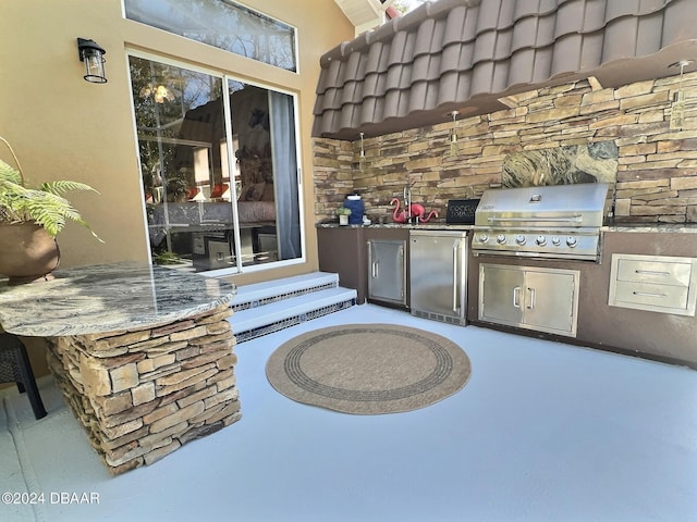 view of patio / terrace featuring a grill and exterior kitchen