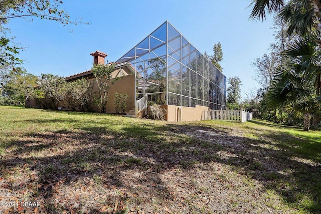 view of yard with glass enclosure