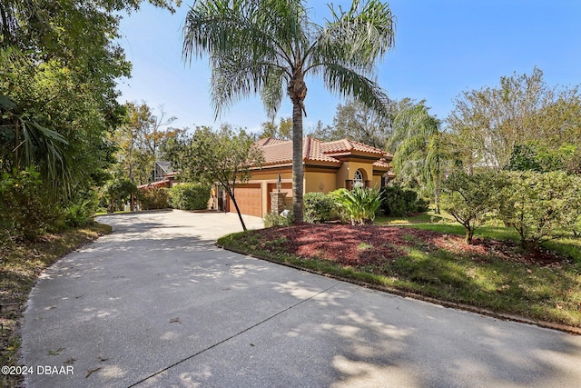 mediterranean / spanish house featuring a garage