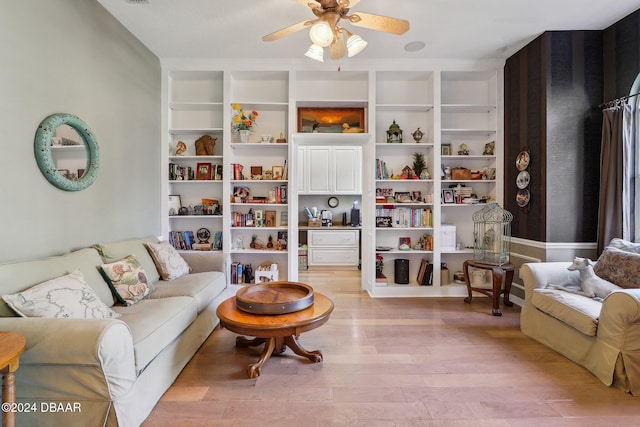 living room featuring ceiling fan and light hardwood / wood-style floors