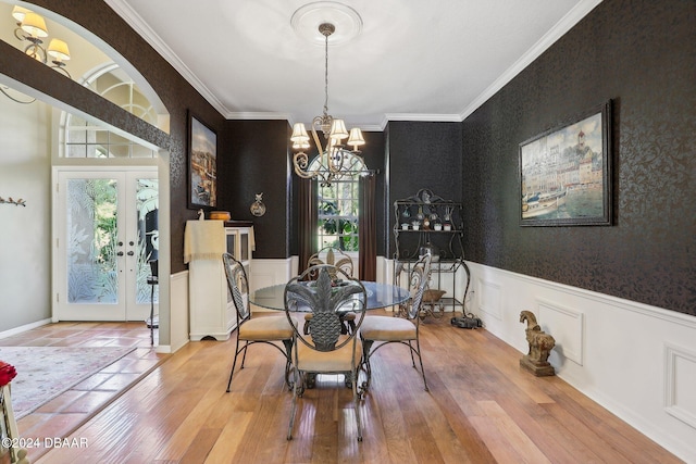 dining room featuring hardwood / wood-style flooring, plenty of natural light, and french doors