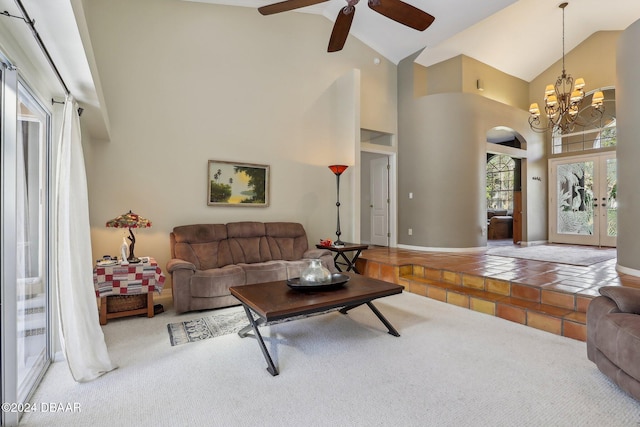 living room featuring carpet, ceiling fan with notable chandelier, high vaulted ceiling, and french doors