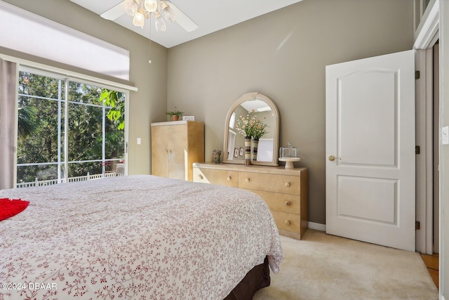 bedroom with ceiling fan, access to exterior, and light carpet