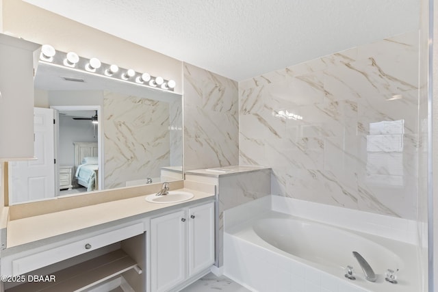 bathroom with visible vents, ensuite bathroom, marble finish floor, a textured ceiling, and a bath