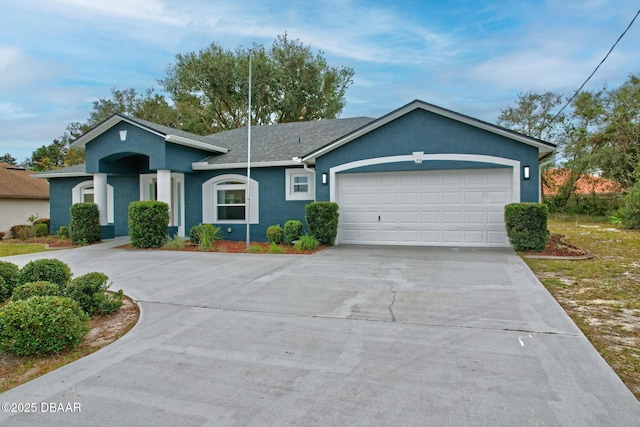 single story home featuring an attached garage, concrete driveway, and stucco siding