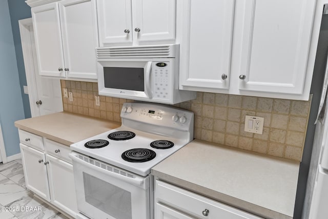 kitchen with white appliances, marble finish floor, light countertops, white cabinetry, and backsplash