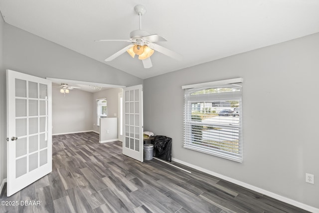 spare room with vaulted ceiling, french doors, wood finished floors, and baseboards