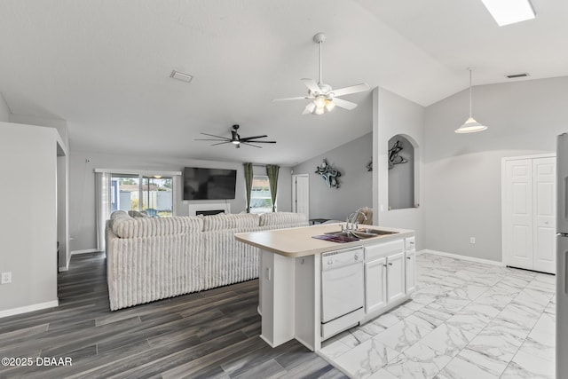 kitchen with marble finish floor, visible vents, white cabinetry, white dishwasher, and a sink