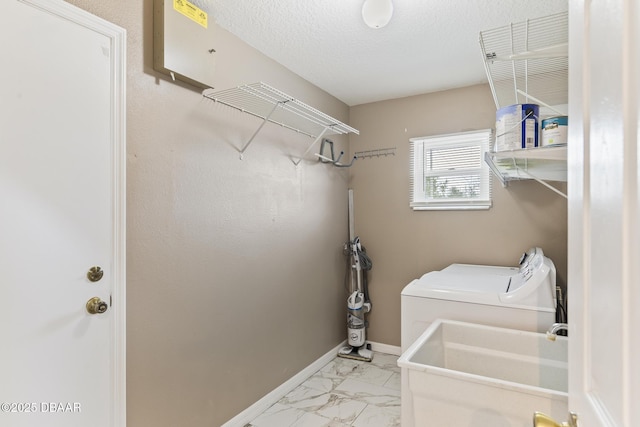 laundry area with laundry area, separate washer and dryer, a sink, baseboards, and marble finish floor