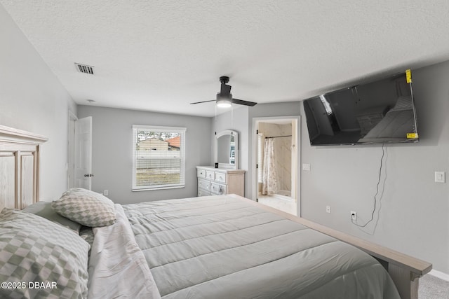 carpeted bedroom featuring a textured ceiling, ceiling fan, connected bathroom, visible vents, and baseboards