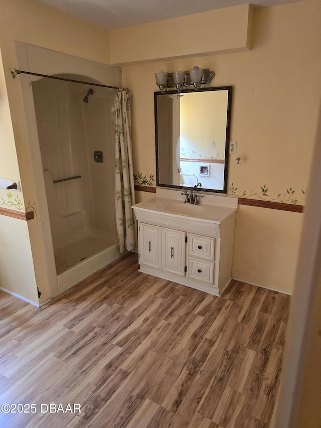full bathroom with vanity, wood finished floors, and a shower with shower curtain