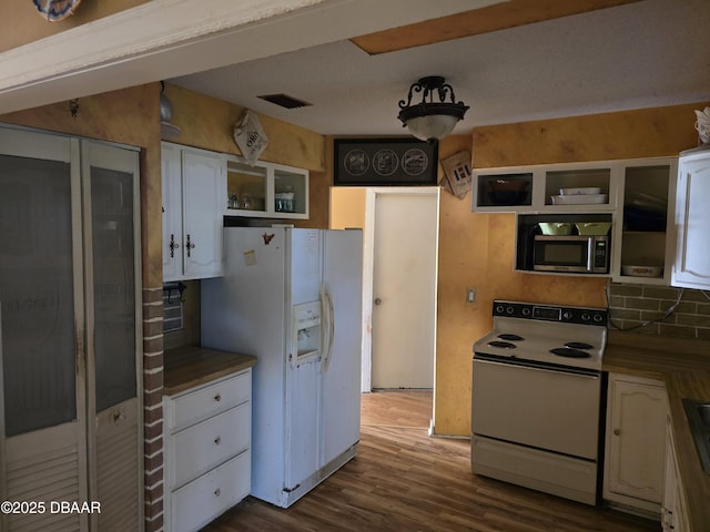 kitchen with white cabinets, visible vents, open shelves, and white appliances