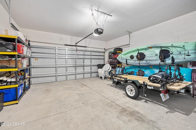 garage with concrete block wall and a garage door opener