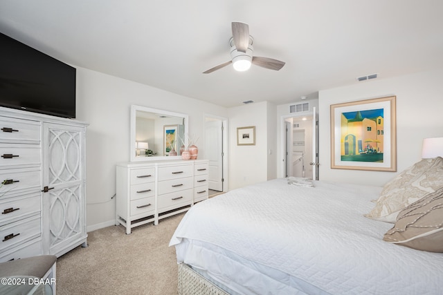 bedroom with light carpet, visible vents, baseboards, and a ceiling fan