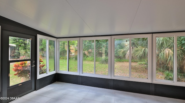 unfurnished sunroom featuring lofted ceiling