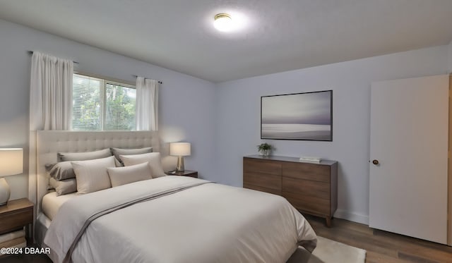 bedroom with hardwood / wood-style flooring