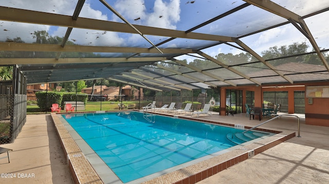 view of swimming pool with a lanai and a patio