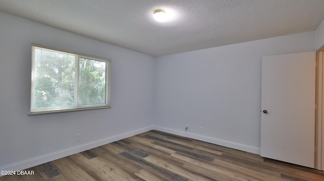 unfurnished room featuring a textured ceiling and hardwood / wood-style flooring