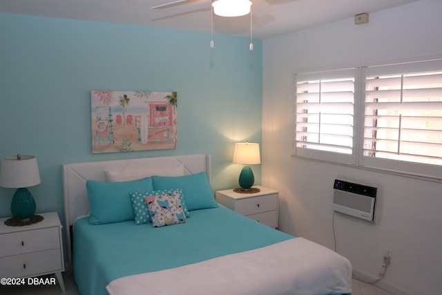 bedroom featuring a wall unit AC and ceiling fan