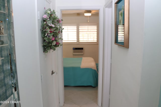 hall featuring a wall mounted air conditioner and light tile patterned floors