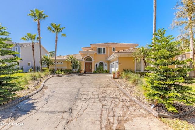 20 Promenade At Lionspaw, Daytona Beach, FL 32124 - mediterranean / spanish home with a tiled roof, decorative driveway, an attached garage, and stucco siding