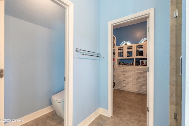 20 Promenade At Lionspaw, Daytona Beach, FL 32124 - full bath featuring a shower with door, baseboards, toilet, and a spacious closet