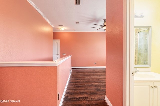 20 Promenade At Lionspaw, Daytona Beach, FL 32124 - hall with dark wood-style floors, baseboards, visible vents, a sink, and crown molding