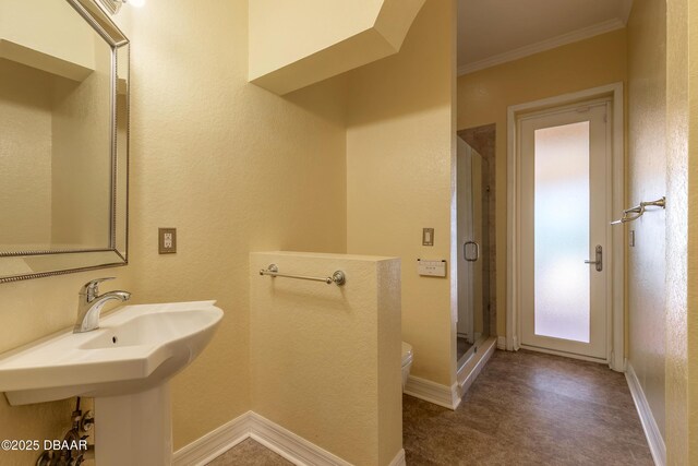 20 Promenade At Lionspaw, Daytona Beach, FL 32124 - full bath with baseboards, toilet, a stall shower, and crown molding