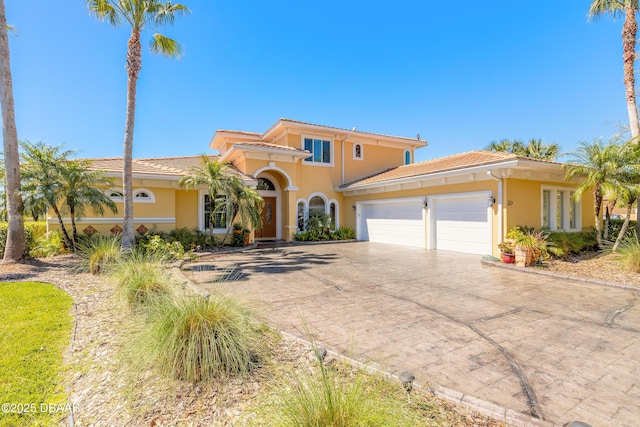 20 Promenade At Lionspaw, Daytona Beach, FL 32124 - mediterranean / spanish house with stucco siding, a tiled roof, decorative driveway, and a garage