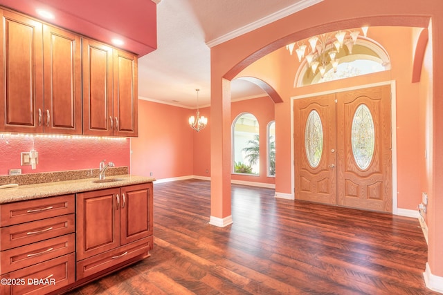 20 Promenade At Lionspaw, Daytona Beach, FL 32124 - entrance foyer with baseboards, an inviting chandelier, dark wood-style flooring, and crown molding